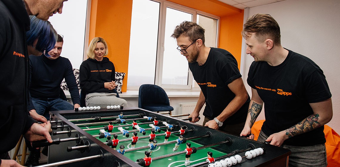 team members playing table football